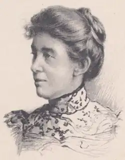 20th-century black and white photo of a middle-aged woman with her hair in an up-do, wearing a high-collared pale blouse.