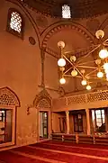 The prayer hall, with the women's upper gallery, and a view of Islamic frescos along the arches and squinches
