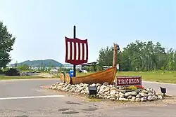 The Erickson viking ship monument in the community, with Leda Lake in the background.