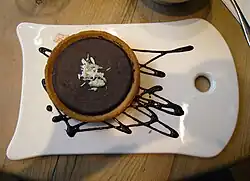An espresso chocolate tart with chocolate sauce