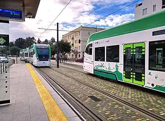 Tram-trains stopping at Reyes Católicos station