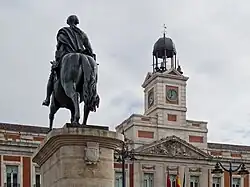 Monument to King Charles III in front of the House of the Post Office
