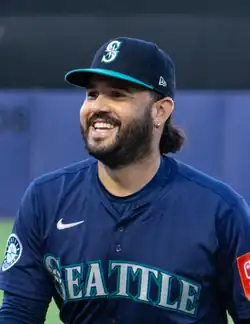 Eugenio Suárez in a Mariners uniform, smiling and looking to his right