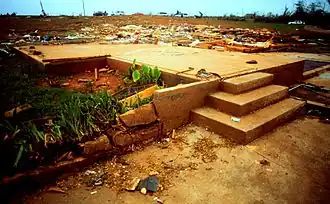 Well-built and well-anchored homes are taken off their foundations and they go into the air before obliteration. The wreckage of those homes is flung for miles and those foundations are swept completely clean. Large, steel-reinforced structures such as schools are completely leveled. Low-lying grass and vegetation are shredded from the ground. Trees are completely debarked and snapped. Very little recognizable structural debris is generated with most materials reduced to a coarse mix of small, granular particles and dispersed. Large, multiple-ton steel frame vehicles and farm equipment are often mangled beyond recognition and tossed miles away or reduced entirely to unrecognizable parts. Tall buildings collapse or have severe structural deformations. The official description of this damage highlights the extreme nature of the destruction, noting that "incredible phenomena can and will occur".