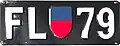 Early Liechtenstein motorcycle license plate (circa 1930) in the then-standard format, featuring the Liechtenstein coat of arms in blue and red. These plates were issued from 1924 to 1961.