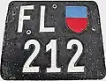 Two-line Liechtenstein license plate in the then-standard square format of 310 × 240 mm, featuring the Liechtenstein coat of arms in blue and red. These plates were issued from 1924 to 1961.