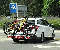 Vehicle with a red repeater license plate / "third license plate" for rear load carriers.