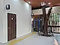 An accessible toilet to the left and a prayer room (musala) in the background