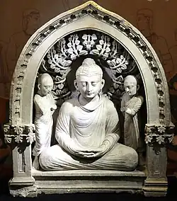 Niche with the Buddha and two monks, 3rd-4th century CE.[15][16]