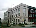 The Canada Revenue Agency offices at 130 South Syndicate Avenue, across from the Victoriaville parkade. Designed by T. W. Fuller and built in 1935 this building served as Fort Williams second post office.[44]