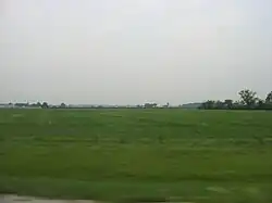 Broad farm fields in southwestern Rice Township