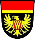 a fillet and a chief—Sable; an eagle displayed or, charged on the breast with an escutcheon gules, thereupon two chevrons couped interlaced inverted or; a chief gules filleted [supported by a fillet] or—Wing Riders of South Africa