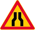 Road narrows on both sides