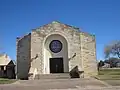 The architecture of the First Baptist Church resembles a fort or other western structure.