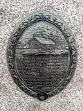 Plaque showing the log chapel and an excerpt of a letter from Lucien Galtier