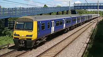 Two trains parked on two platforms. The photo is of the last vehicles of two trains next to each other.