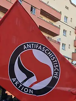 The logo of Antifaschistische Aktion on a red flag