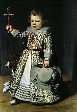Young Boy of 1625 wearing a gown and kirtle shortened by deep tucks near the hem.