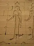 Relief of a woman in Egyptian clothing with an elaborate headdress