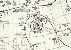 Map showing shorelines and the coordinate grid in light gray. Black contours on the map denote isobars; the presence of concentric isobars at the center of the image denote the location of a tropical cyclone.