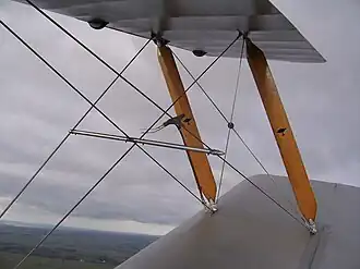 Yellow struts and wire rope stays on a de Havilland Tiger Moth