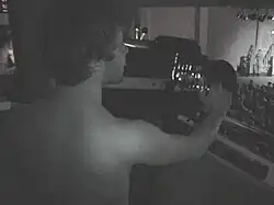 black and white image of a man operating a spotlight