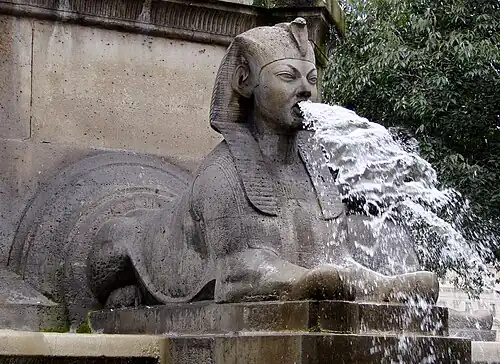 Stone sphinx fountain with water gushing from its mouth