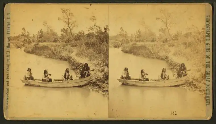 Four Indian men in a boat on Ponca creek