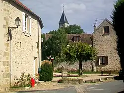The fountain in Frémainville, with the church in the background
