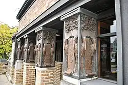 Architectural details of the studio wing. In the foreground are ornately decorated columns.