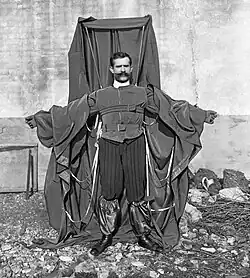 A man wearing a frame draped in material