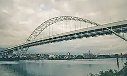 Pale green metal arched bridge