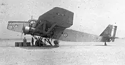 Photo of a plane on the tarmac, in profile, with tricolor emblem.