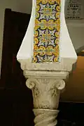 Ornamental features of an archway: ceramic frieze, abacus and capital.