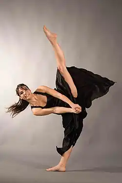 A contemporary dancer performs a tilt.