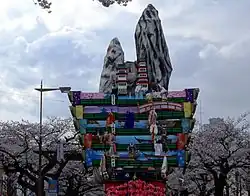 Tall colorful structure with multiple levels for dolls.