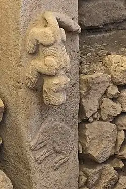 Pillar&nbsp;27, Enclosure&nbsp;C: predator (perhaps a felid) hunting a boar.[95]