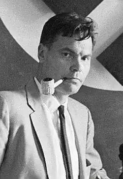 Black and white profile shot of Rockwell with a corncob pipe in his mouth