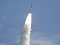 Fire and smoke light up a blue sky as a United Launch Alliance Delta II Heavy rocket propels GRAIL into space.
