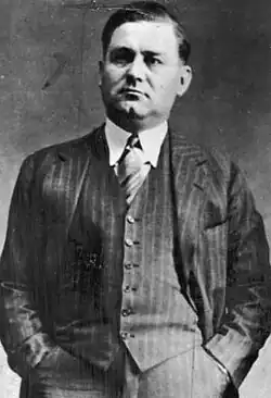 Black-and-white headshot of Moran in a suit