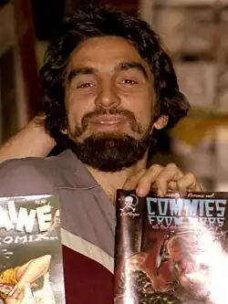 George DiCaprio and Ron Turner holding up comic books including Commies from Mars and Cherry Poptart