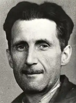 Head shot of a middle-aged Orwell, with dark hair and a slim mustache