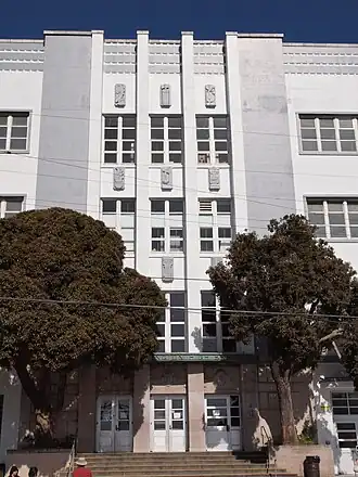 A four story white and grey building