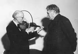 Georges Frey demonstrating the curved bow to Albert Schweitzer