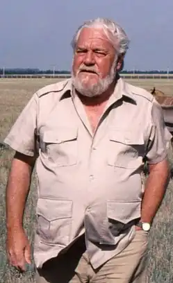 Bearded man in an open-necked shirt