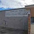 Sign advertising the office of the first newspaper to serve Rio Vista, The River News Herald.