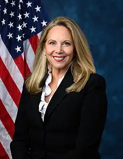 Official House portrait of Gillen smiling in front of the U.S. flag, wearing a black blazer jacket.