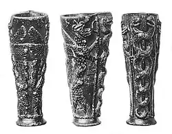 The "Libation vase of Gudea" with the dragon Mušḫuššu, dedicated to Ningishzida (21st century BC). The caduceus (right) is interpreted as depicting god Ningishzida. Inscription; "To the god Ningiszida, his god, Gudea, Ensi (governor) of Lagash, for the prolongation of his life, has dedicated this."