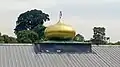 A closeup of the golden dome of Masjid Omar Salmah