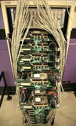 A picture of Google's first servers. The photo shows lots of primarily exposed beige wiring and multicolored circuit boards